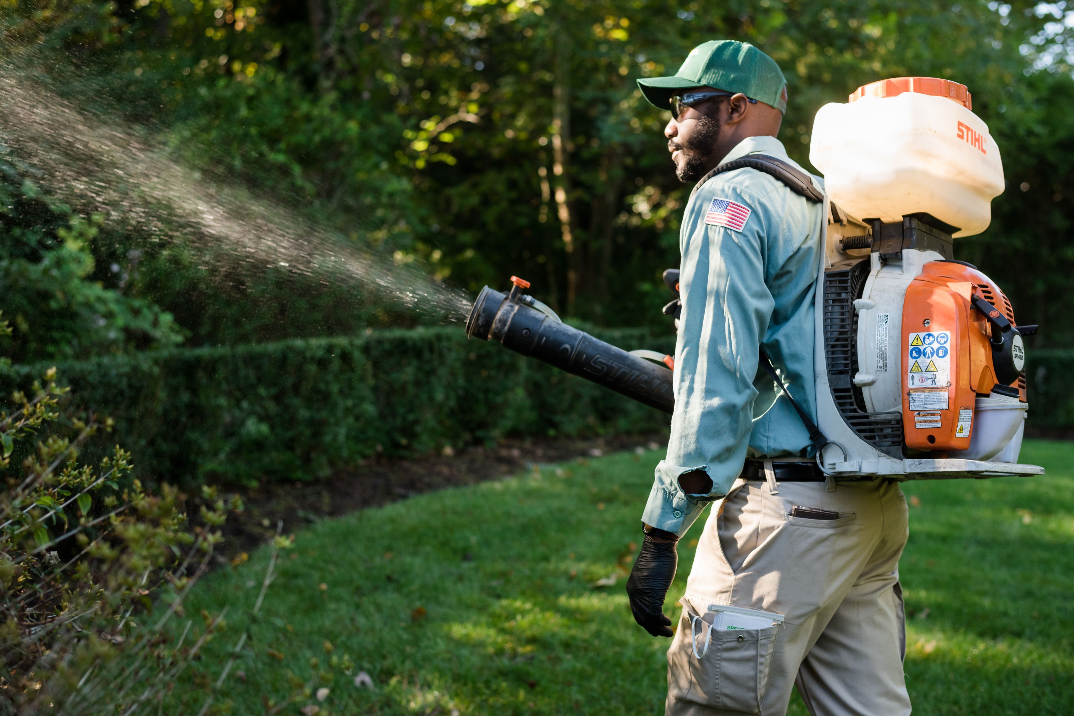 turf doctor augusta lawn technician spraying for mosquitos