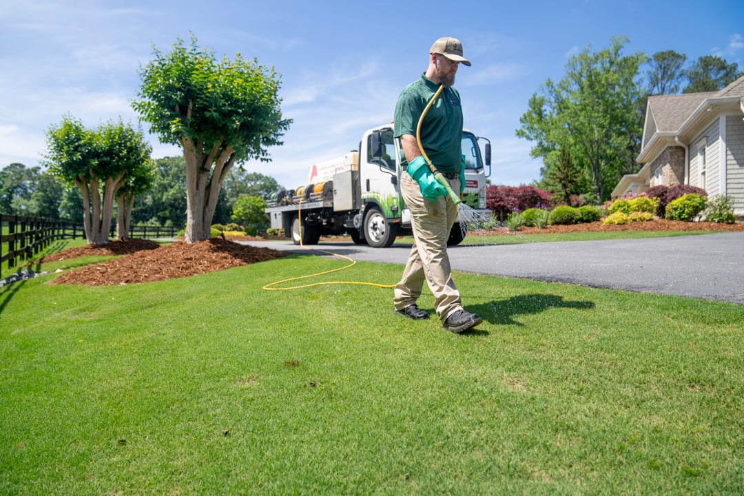 turf doctor hallowell lawn tech applying liquid aeration treatment to lawn