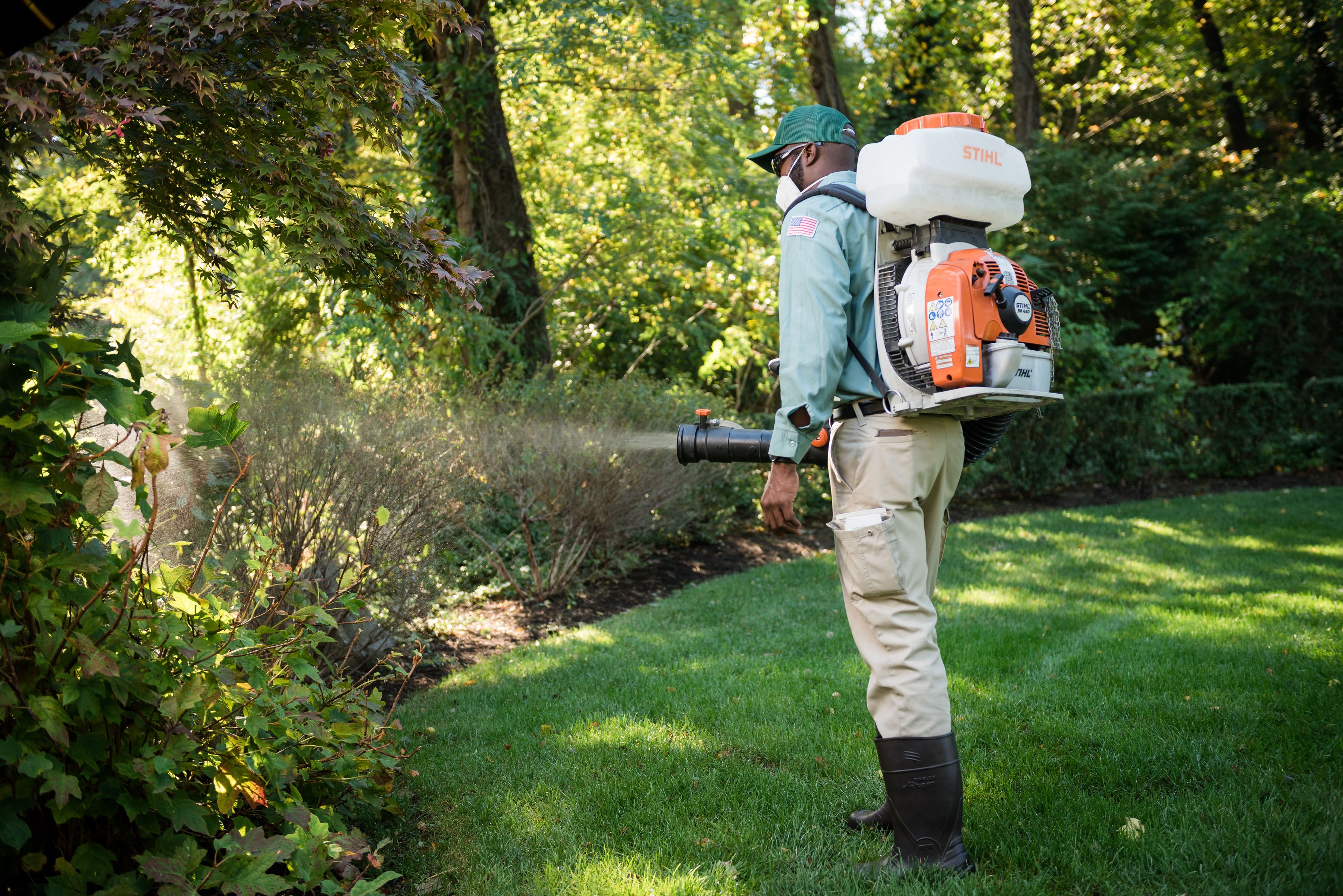 turf doctor lawn technician applying pest control treatment in winthrop